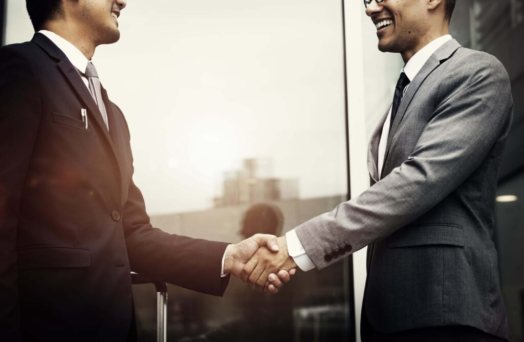 corporate businessmen shaking hands min 1