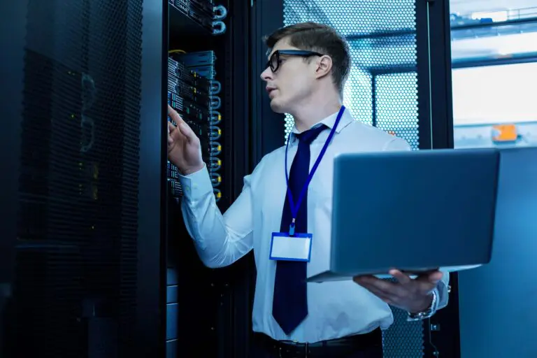 satisfied with work determined smart man working with equipment holding laptop min 2