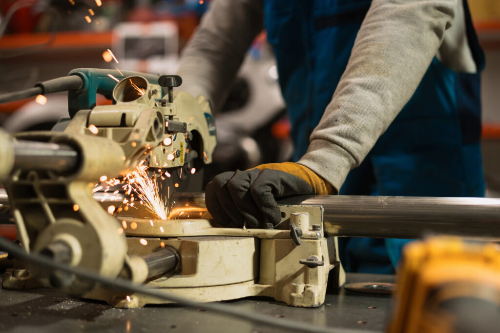 worker working with circular grinder metal with sparks